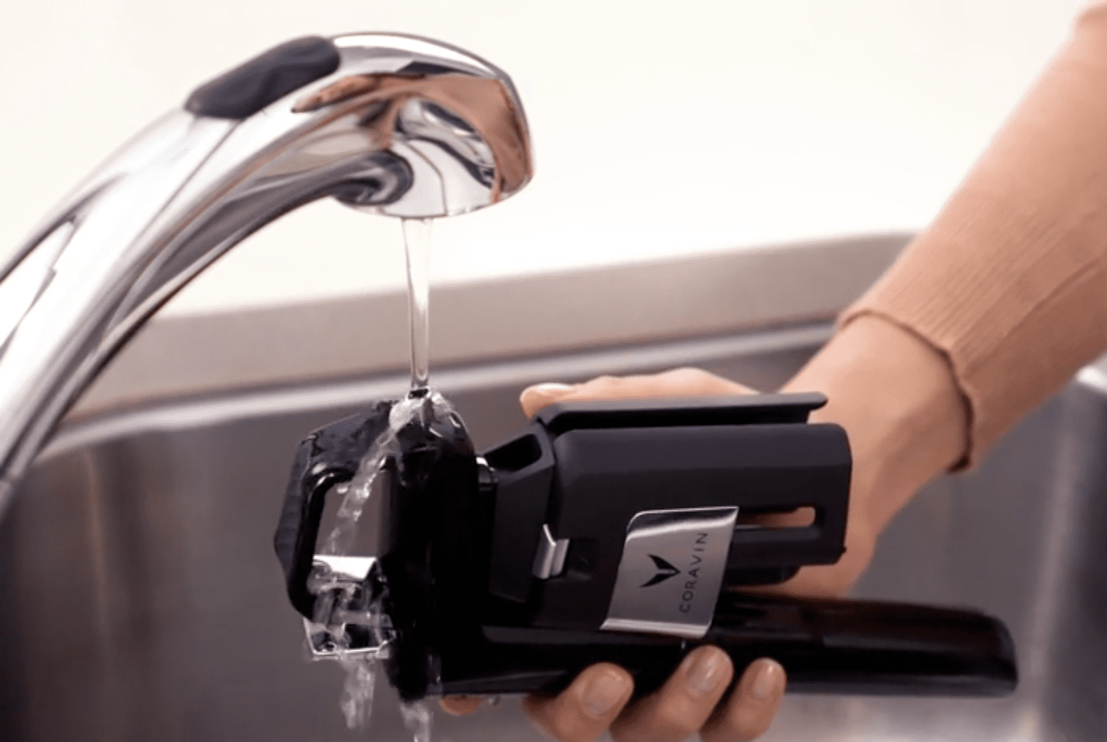 coravin system being cleaned under the tap