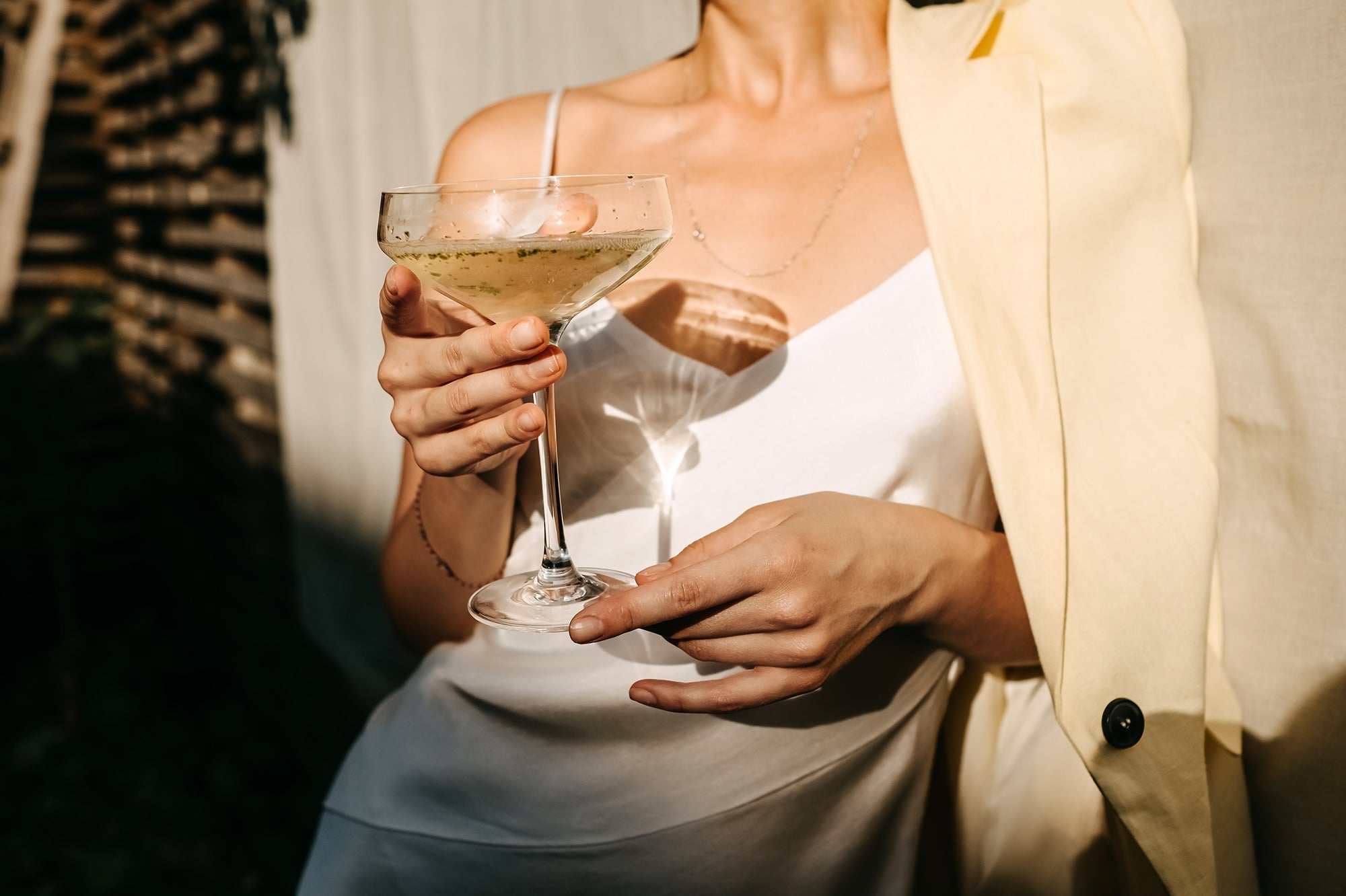 what is champagne - woman holding champagne coupe glass