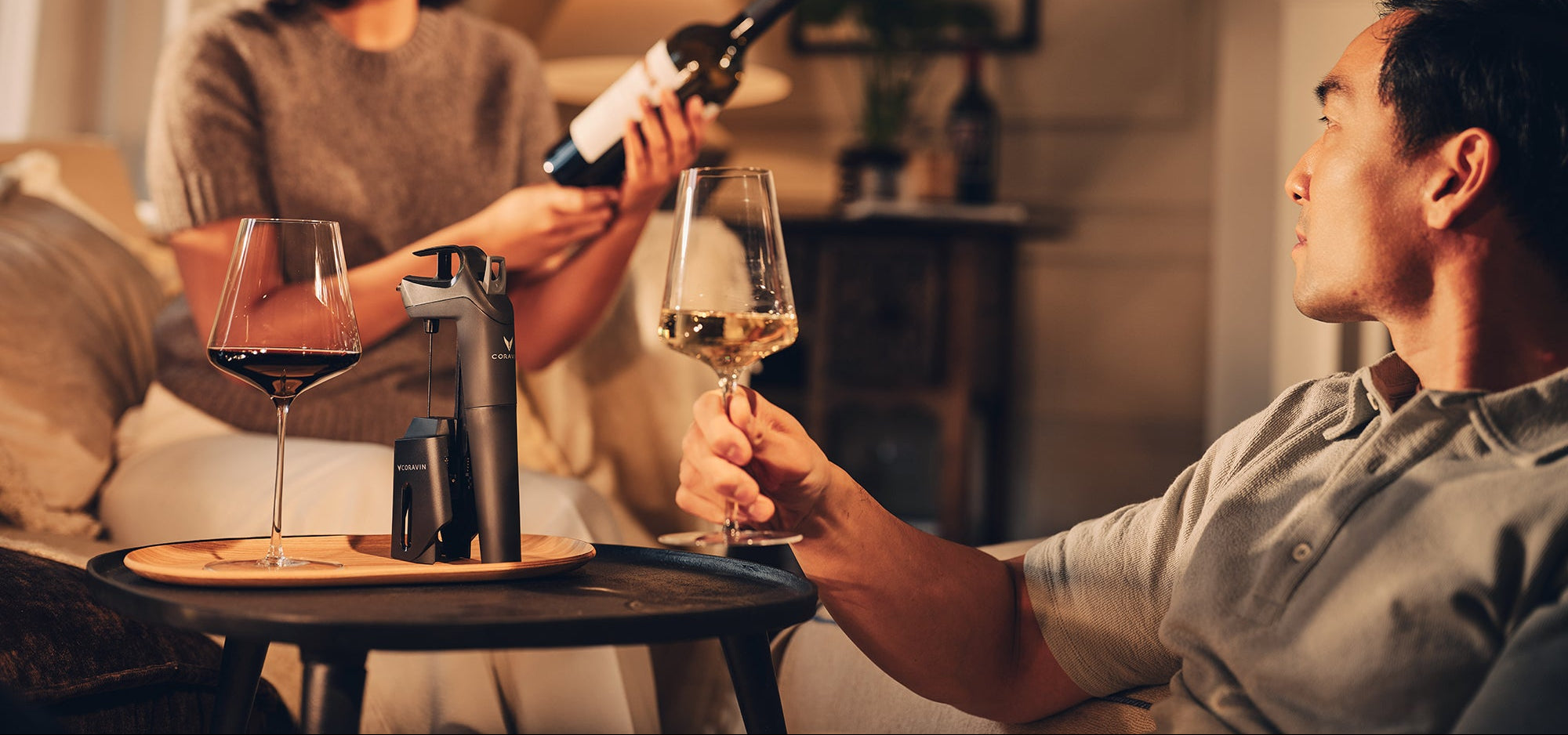 man and woman enjoying a glass of wine with Coravin