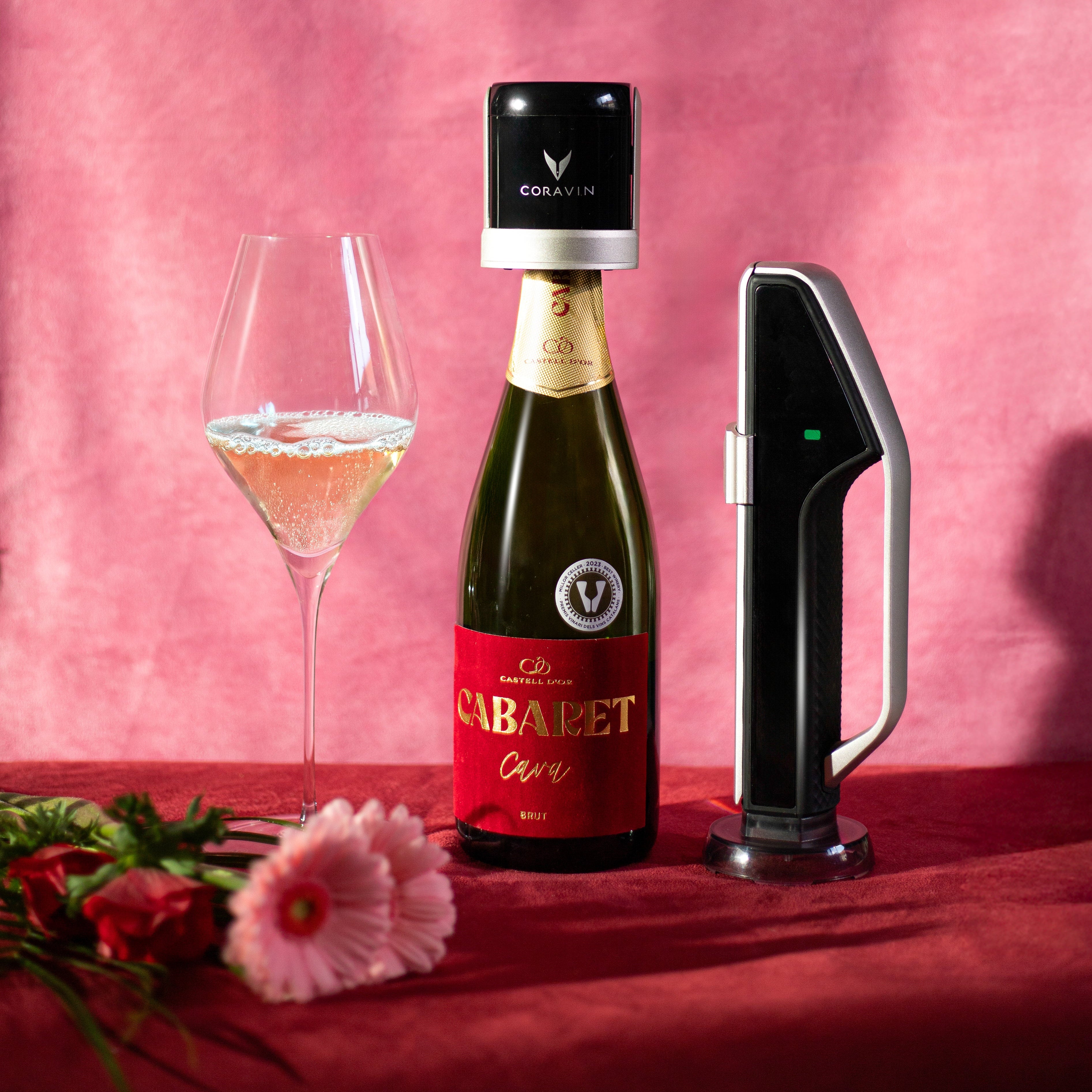 Bottle of Céline Cébalet wine with coravin sparkling and glass on a pink background
