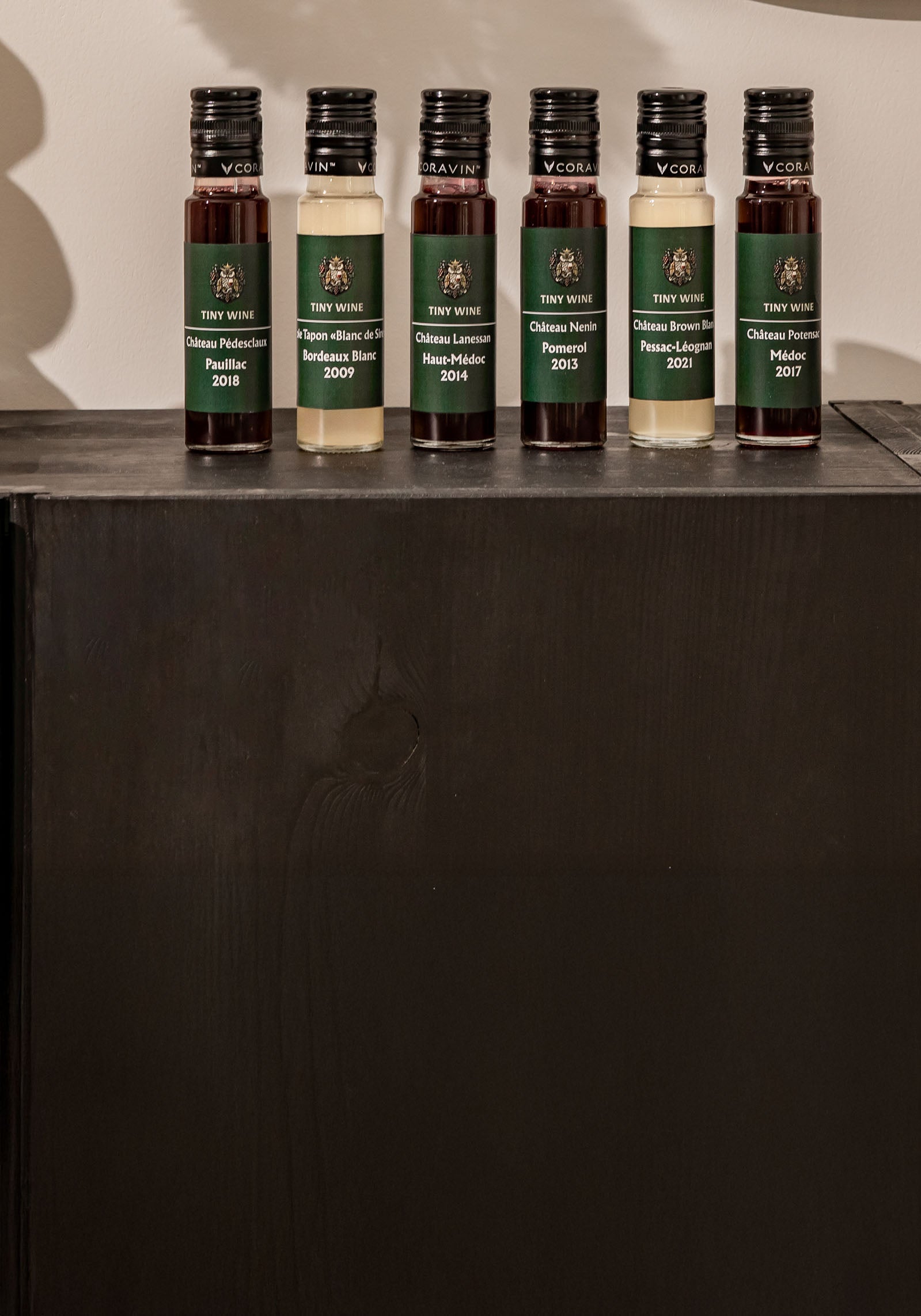 Set of wine kit bottles on a dark surface with decorative elements